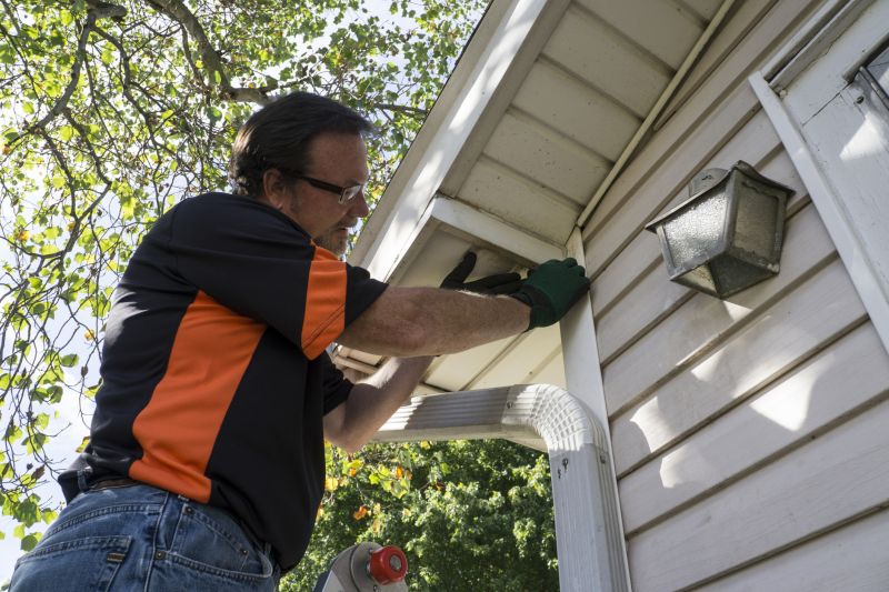 Repair Technician Installing Siding